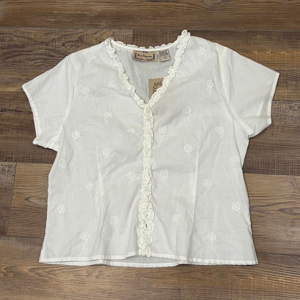 White 100% white cotton blouse with small floral embroidery and ruffle detail